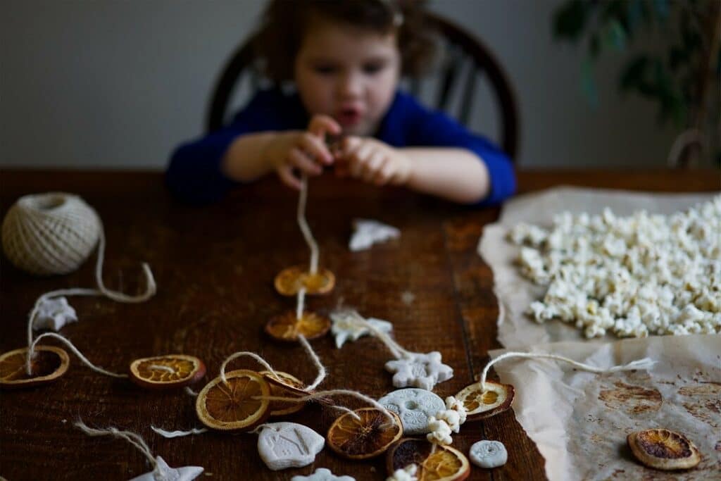 Toddler sitting at the table and crafting