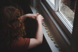 A child exploring schema play. Lining up beans as part of the positioning schema.